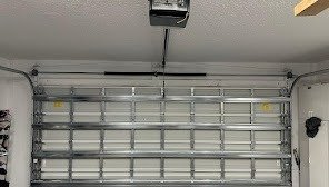 Sectional garage door and ceiling-mounted opener seen from inside